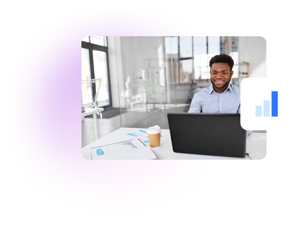 a man sitting at a desk with a laptop