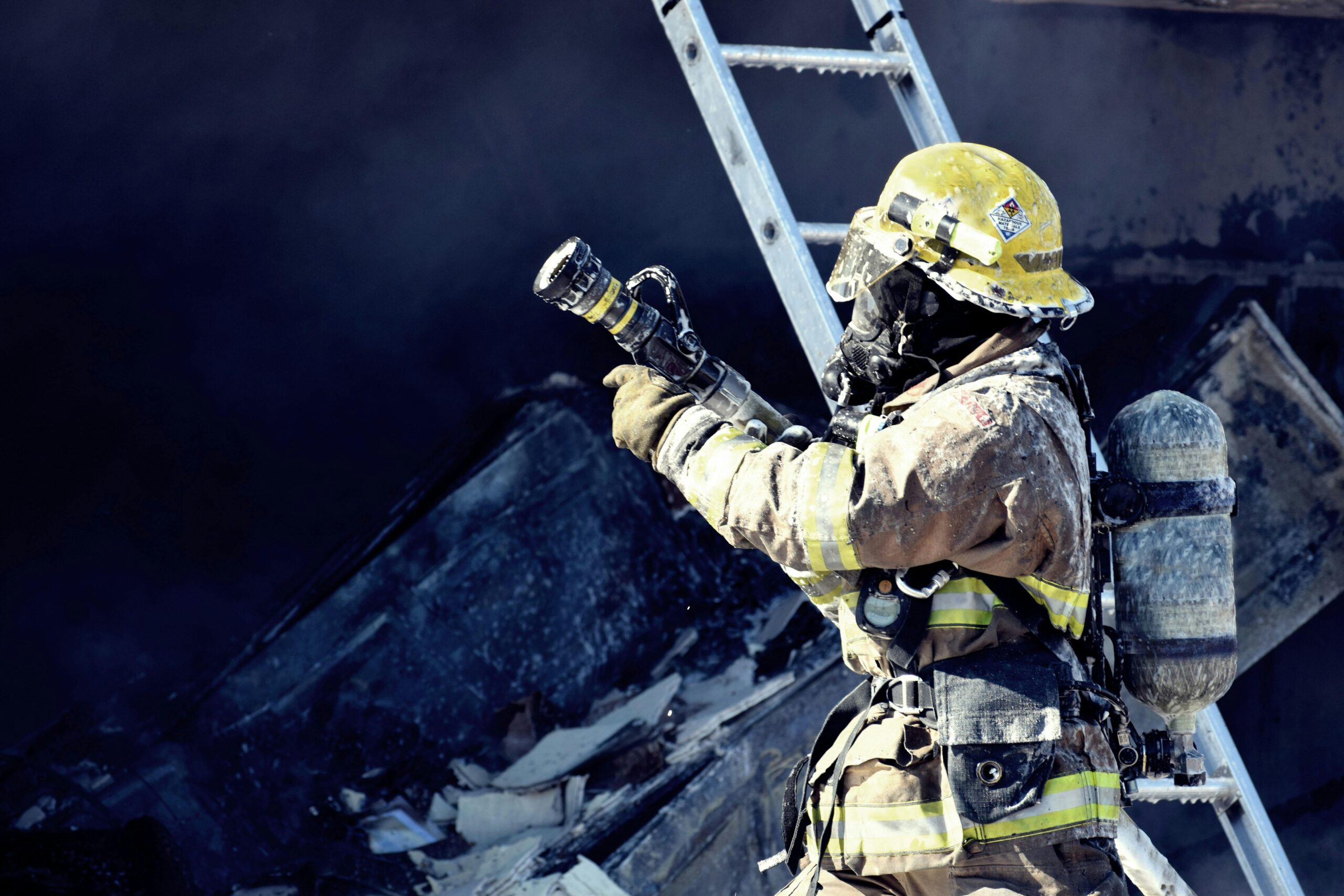 a firefighter holding a ladder